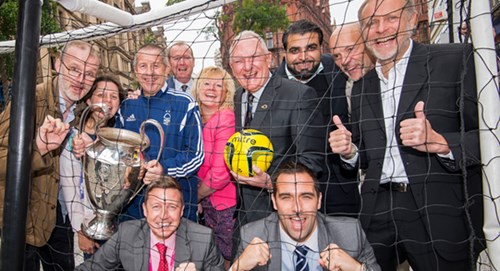 Members of the winning City of Football bid team celebrate in the Market Square